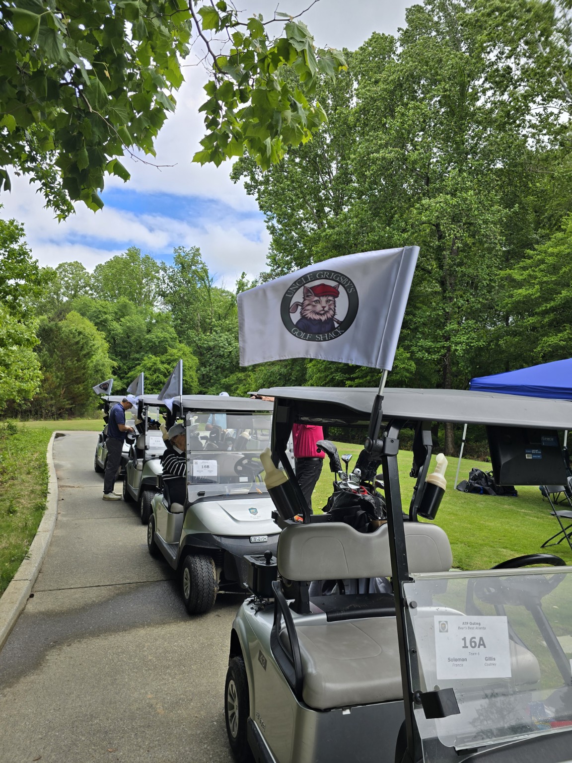 Line of golf carts flying Shack flags